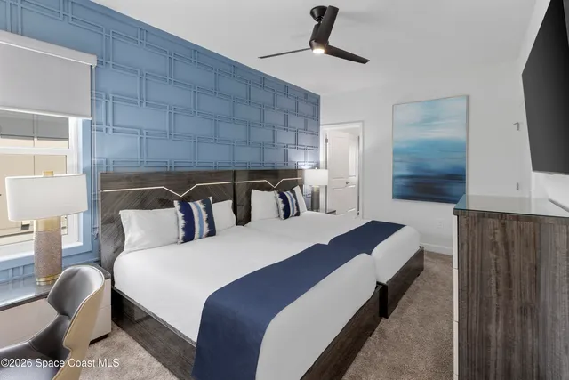 a bed room with a bed and a television