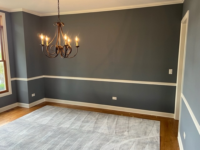 10902 Zarnstorff Road Richmond, IL 60071 - Photo 12 of 14 a view of an empty room with chandelier fan and kitchen view