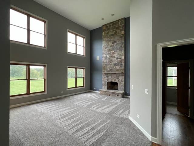 10902 Zarnstorff Road Richmond, IL 60071 - Photo 6 of 14 an empty room with windows and fireplace