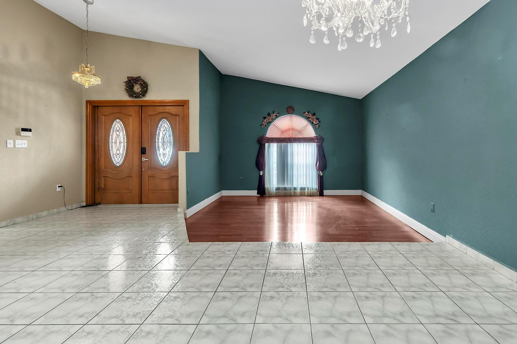 3201 West 76th Street Hialeah, FL 33018 - Photo 13 of 46 a view of a hallway with entryway wooden floor and front door