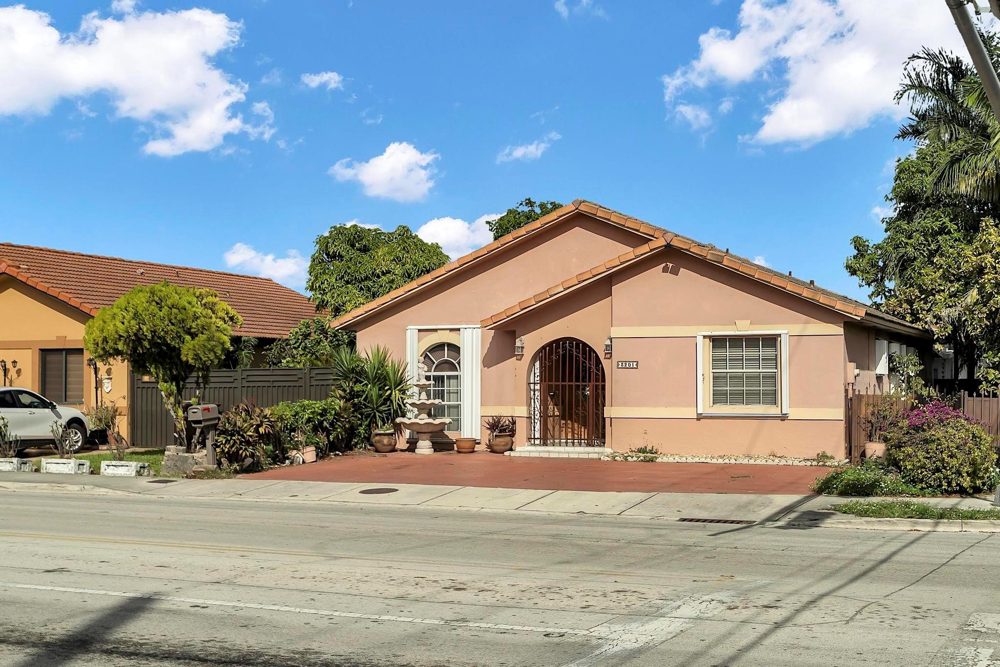 3201 West 76th Street Hialeah, FL 33018 - Photo 2 of 46 a front view of a house with a yard