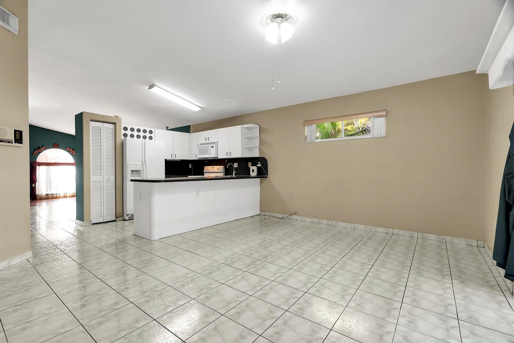 3201 West 76th Street Hialeah, FL 33018 - Photo 24 of 46 a view of kitchen with cabinets and refrigerator