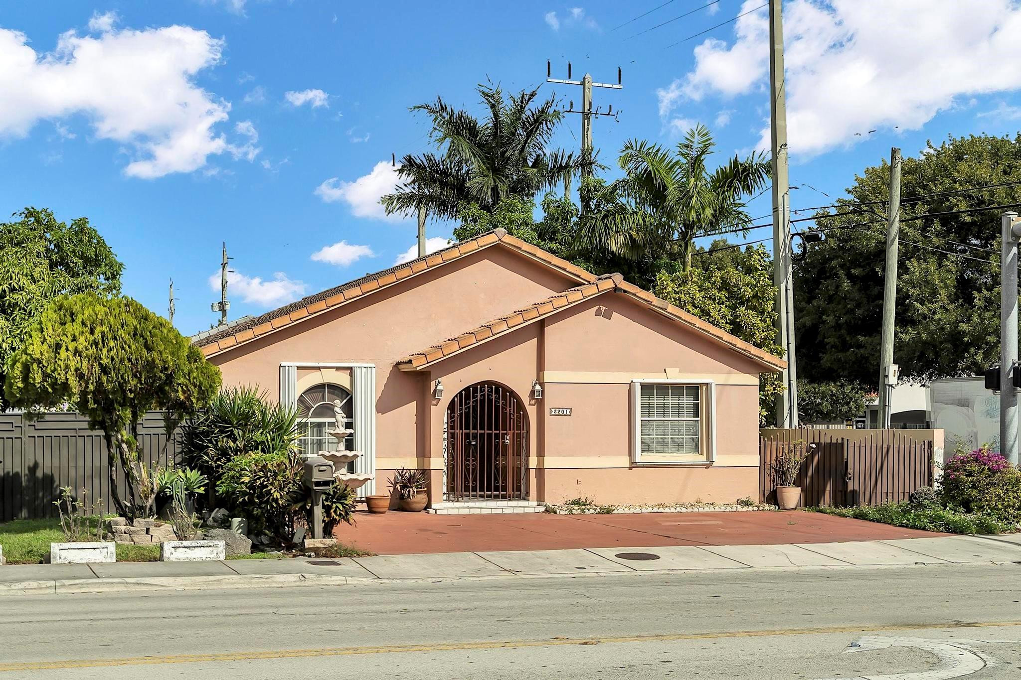 3201 West 76th Street Hialeah, FL 33018 - Photo 3 of 46 a view of a white house with a yard and potted plants