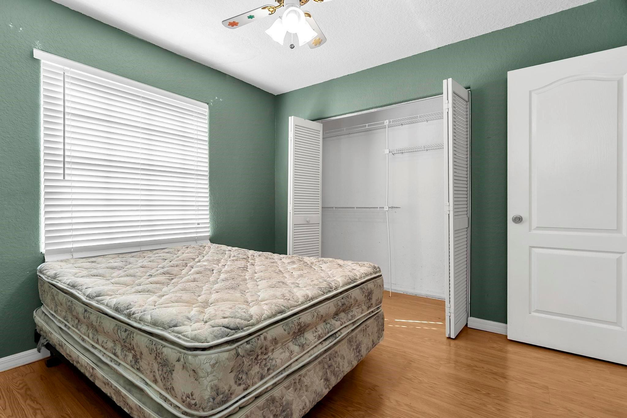 3201 West 76th Street Hialeah, FL 33018 - Photo 36 of 46 a bed sitting in a bedroom next to a window