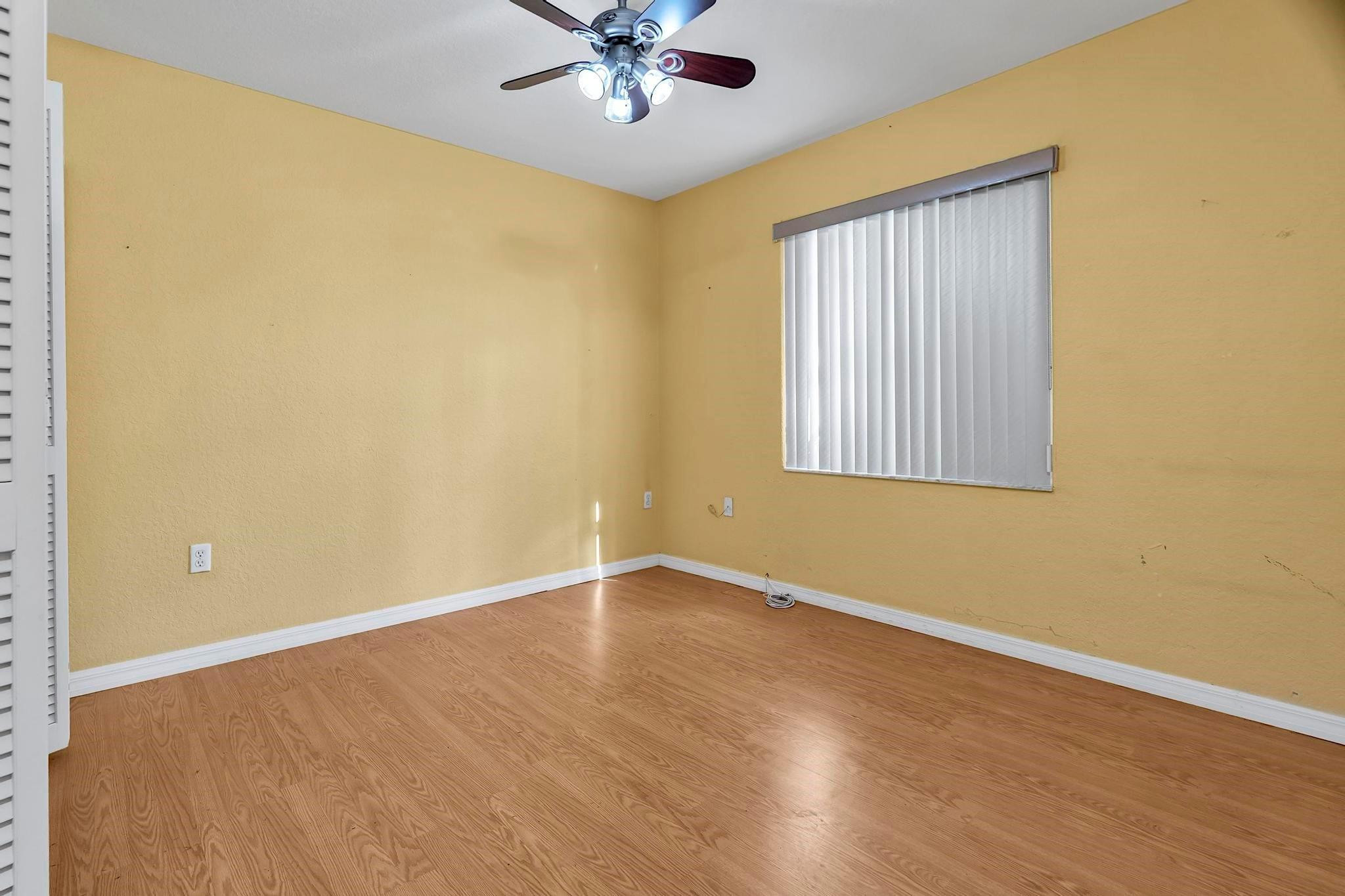 3201 West 76th Street Hialeah, FL 33018 - Photo 38 of 46 a view of an empty room with wooden floor and a window
