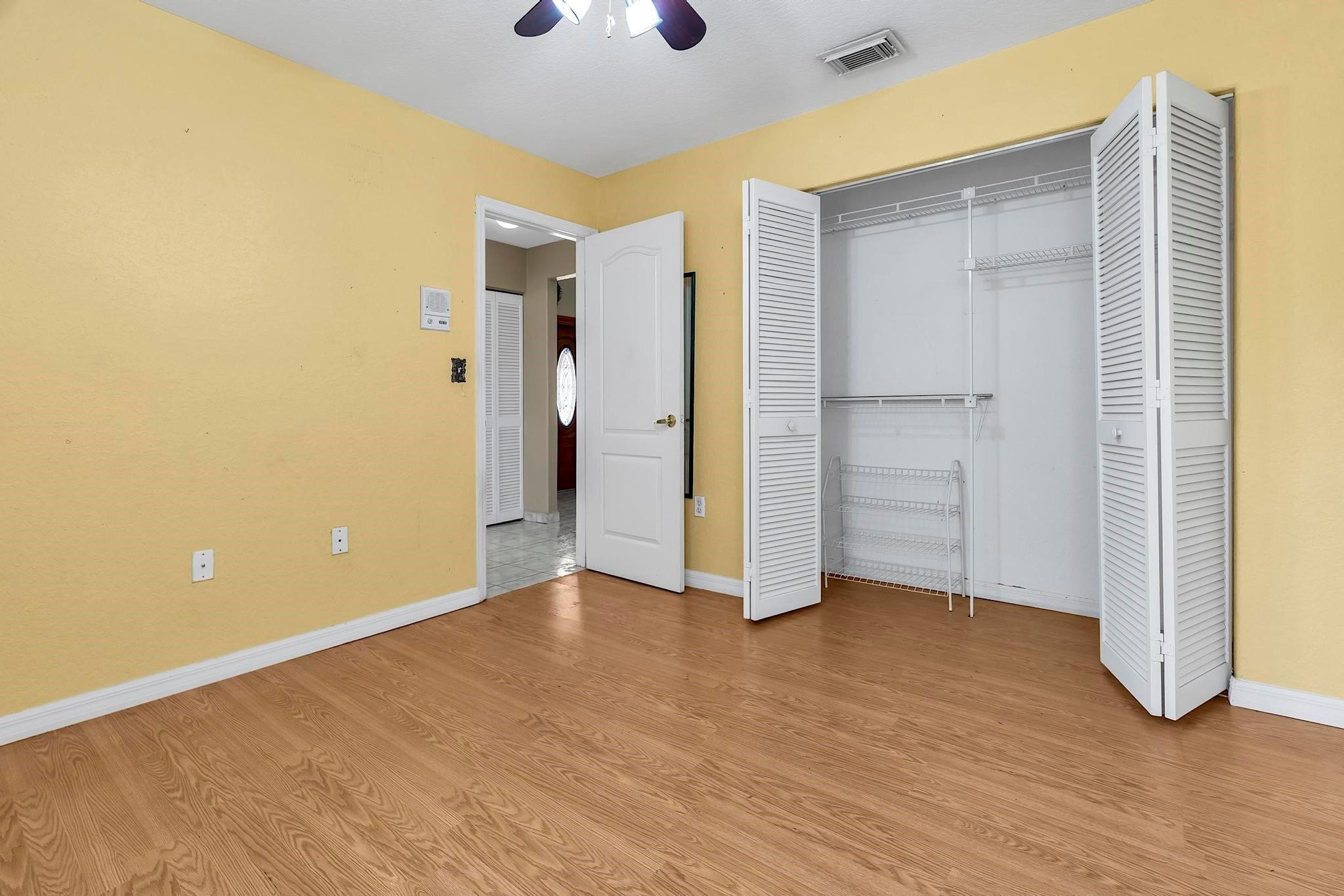 3201 West 76th Street Hialeah, FL 33018 - Photo 39 of 46 a view of an empty room with wooden floor and a window