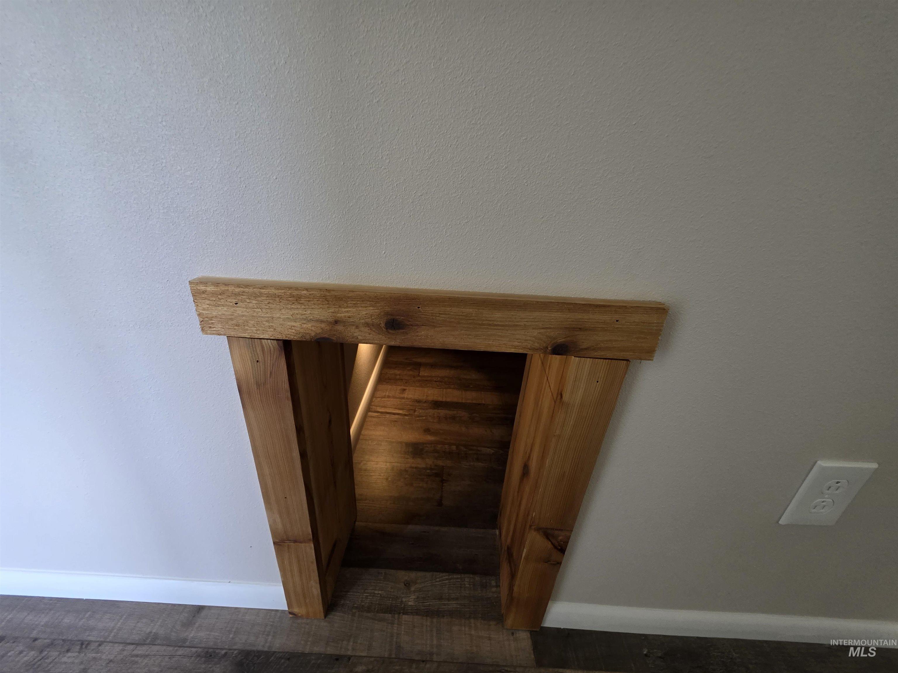 107 Pine Road Kamiah, ID 83536 - Photo 19 of 41 Custom wooden archway leading to a recessed area with wood-finish flooring