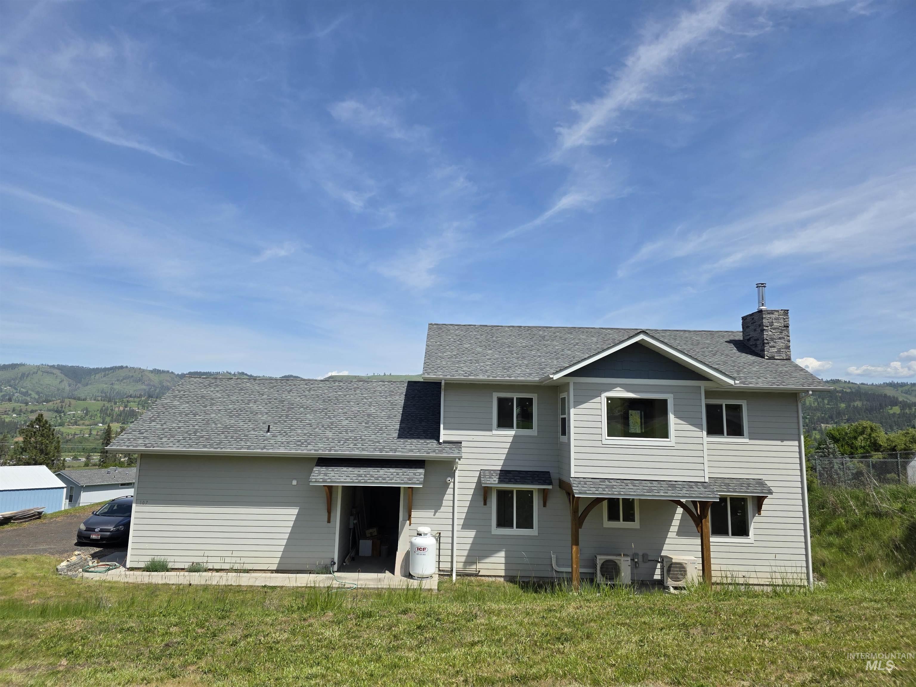 107 Pine Road Kamiah, ID 83536 - Photo 2 of 41 Two-story residence featuring light gray siding with contrasting dark blue gables