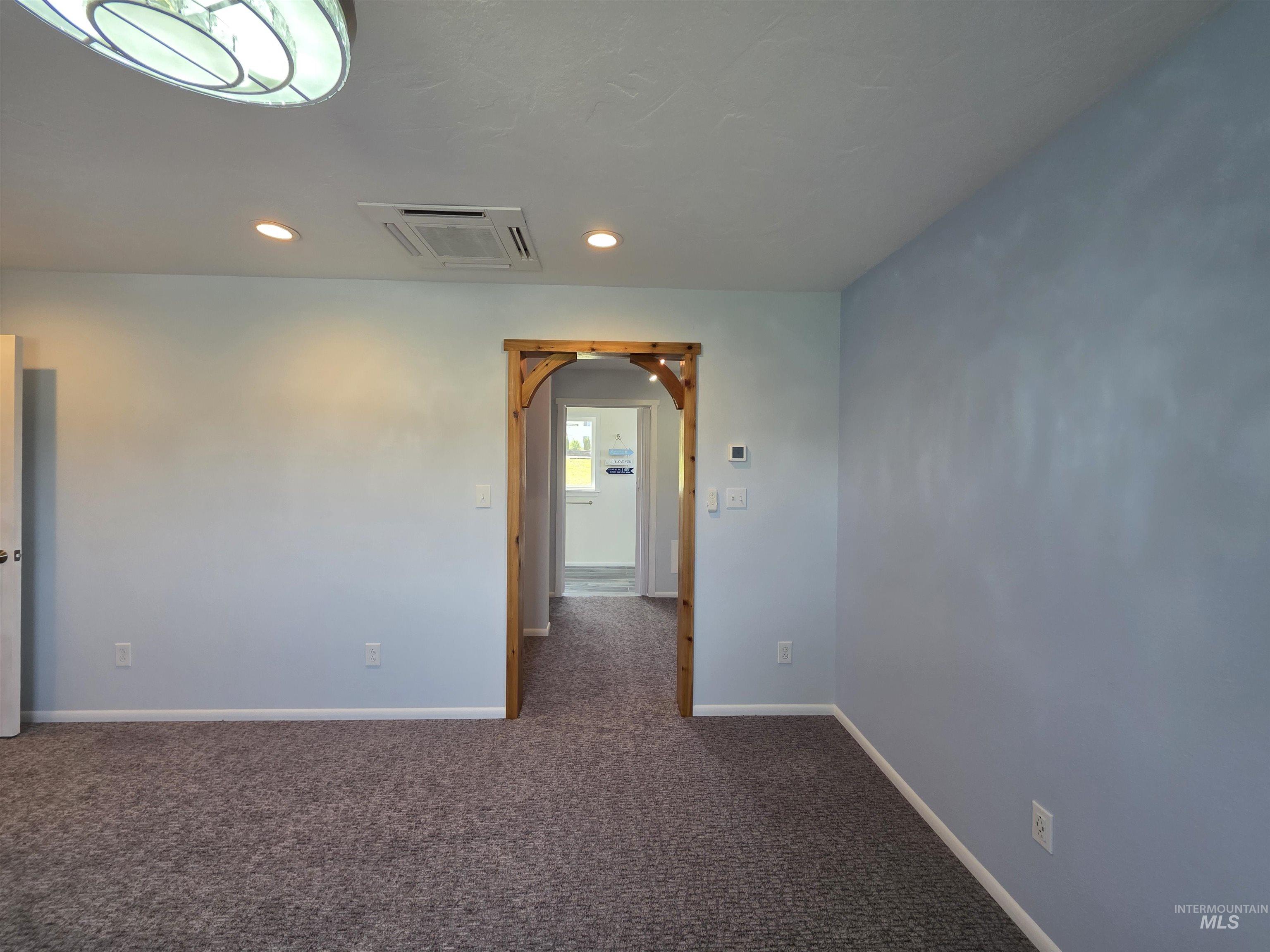 107 Pine Road Kamiah, ID 83536 - Photo 24 of 41 Carpeted room with light blue walls and recessed lighting
