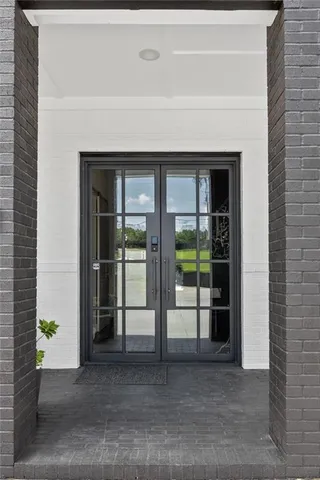 a view of a living room with furniture and a chandelier