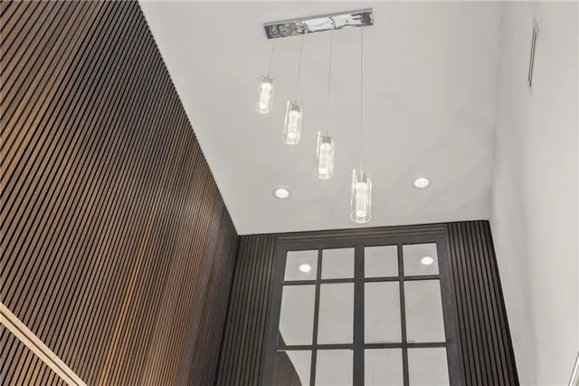 a view of walk in closet with clothes and window