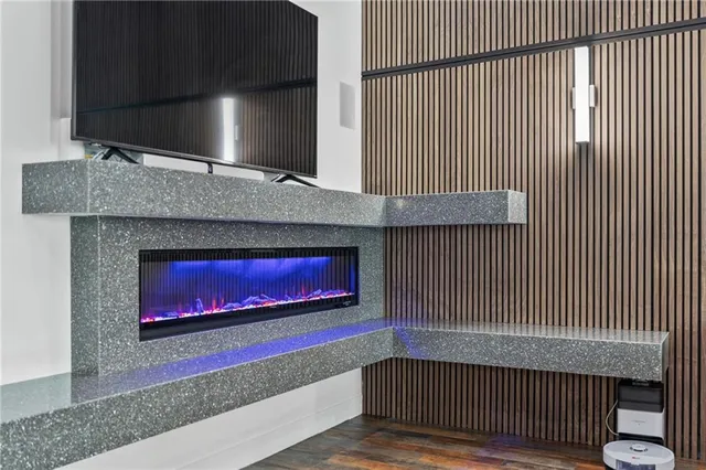 a view of a white house with a yard and large trees