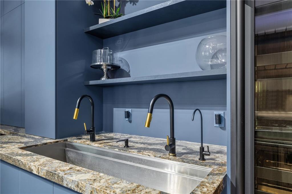 3240 Smithtown Road Suwanee, GA 30024 - Photo 29 of 94 a kitchen with stainless steel appliances granite countertop a sink and a wooden floor