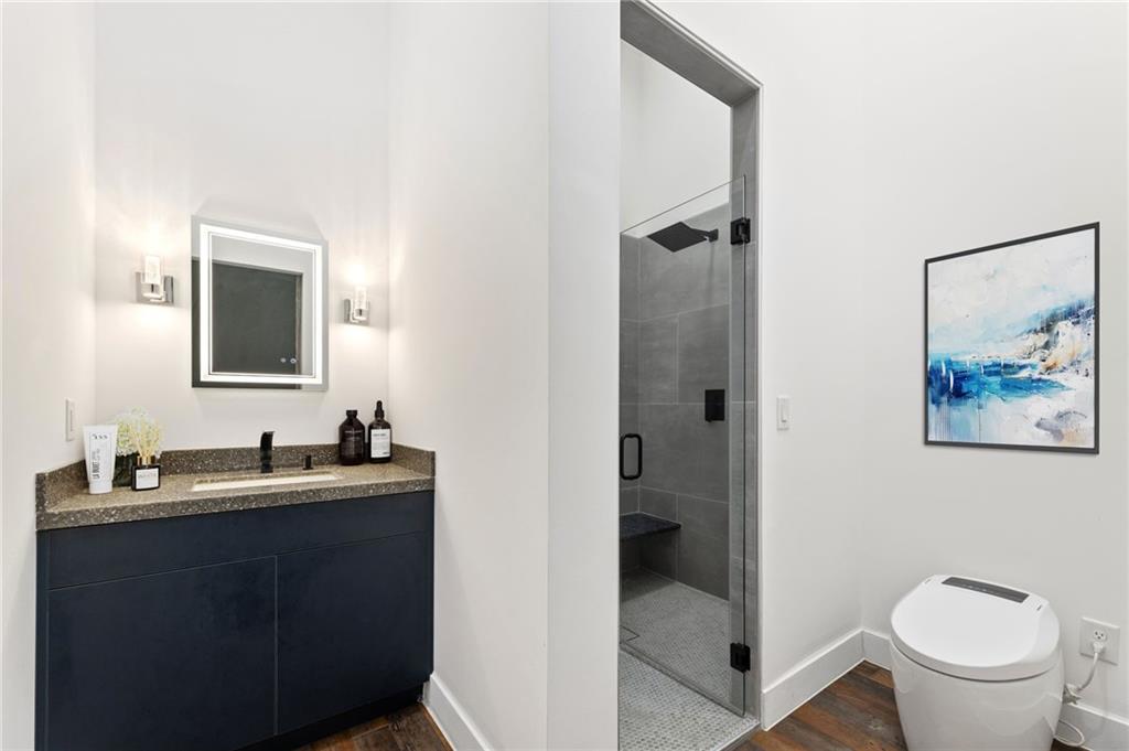 3240 Smithtown Road Suwanee, GA 30024 - Photo 46 of 80 a bathroom with a toilet a sink and mirror