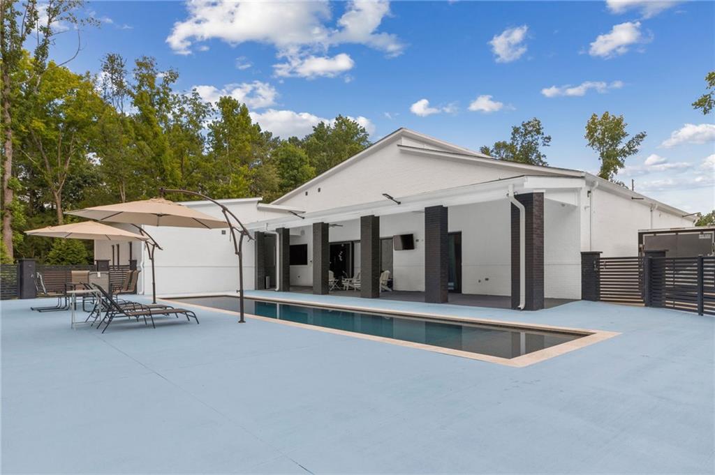 3240 Smithtown Road Suwanee, GA 30024 - Photo 69 of 94 a view of a white house with swimming pool and sitting area