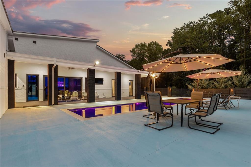 3240 Smithtown Road Suwanee, GA 30024 - Photo 73 of 94 a view of a patio with a table and chairs under an umbrella with a patio