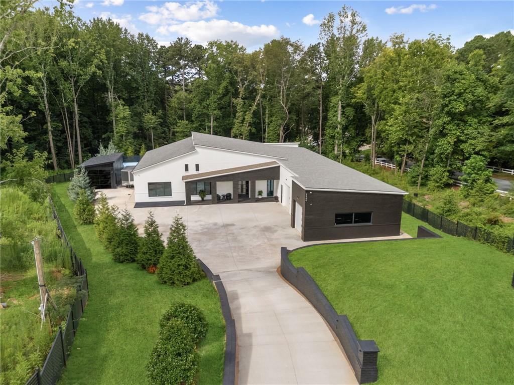 3240 Smithtown Road Suwanee, GA 30024 - Photo 84 of 94 a view of a white house with a yard and large trees