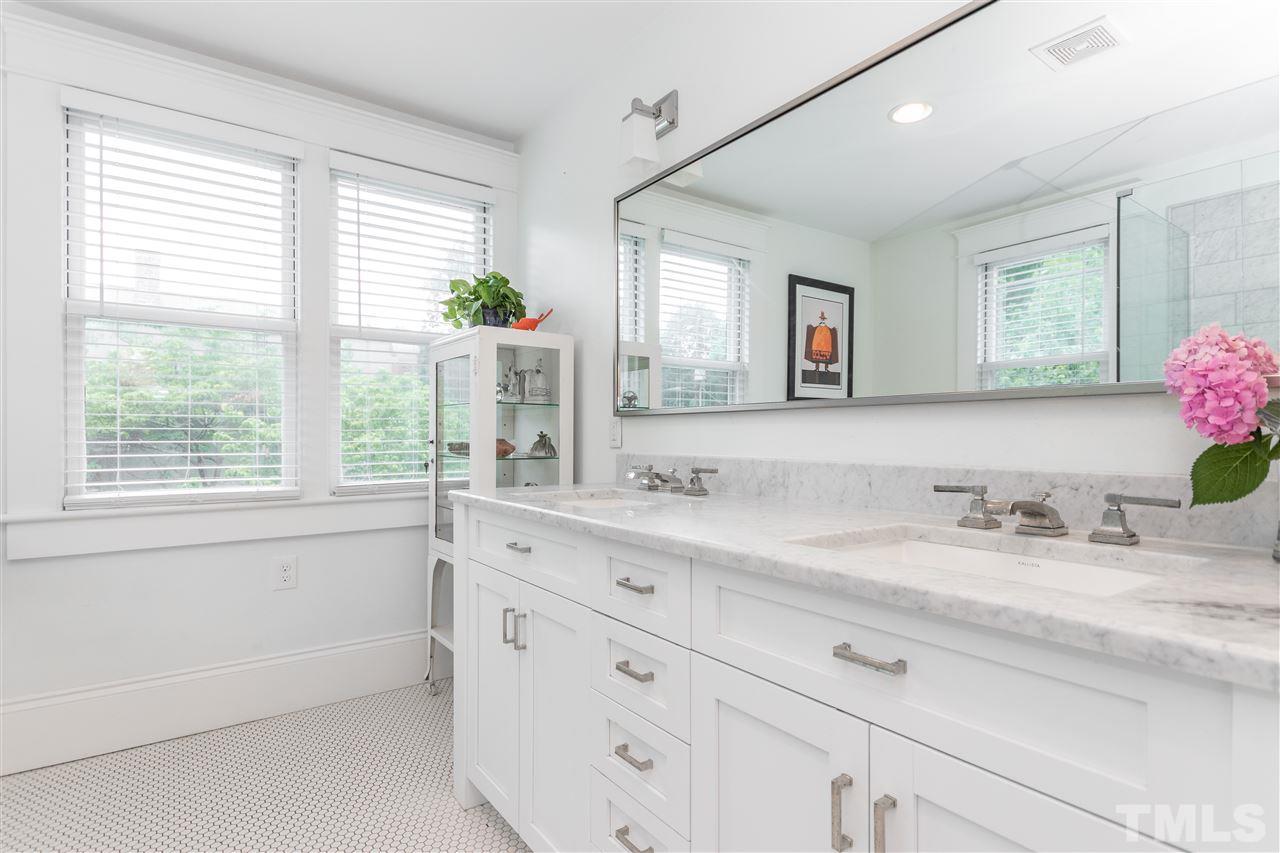 203 Forest Road Raleigh, NC 27605 - Photo 24 of 30 a bathroom with a granite countertop sink mirror and a window