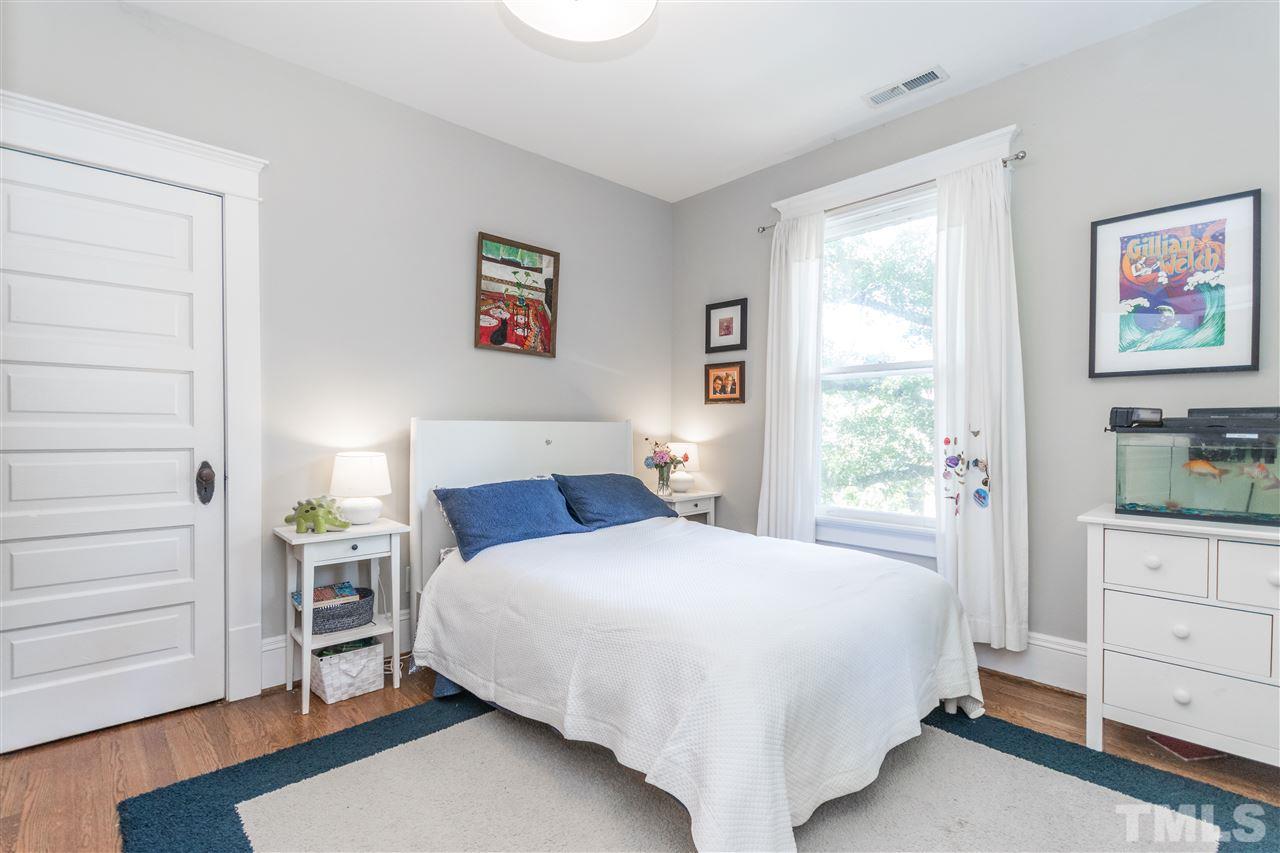 203 Forest Road Raleigh, NC 27605 - Photo 25 of 30 a bedroom with a bed and a window