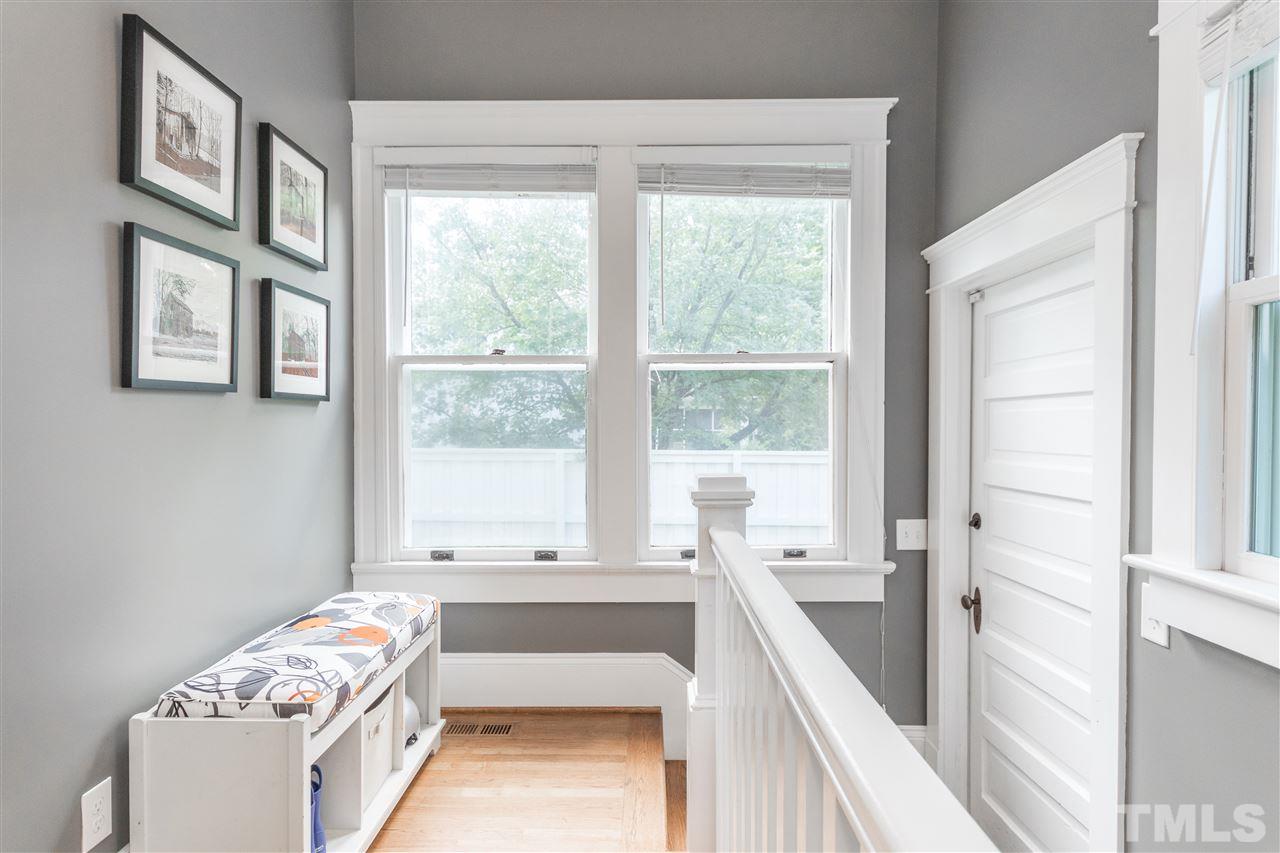 203 Forest Road Raleigh, NC 27605 - Photo 27 of 30 a bedroom with a bed and a window