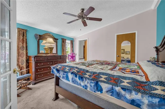 a bedroom with a bed and a dresser in it