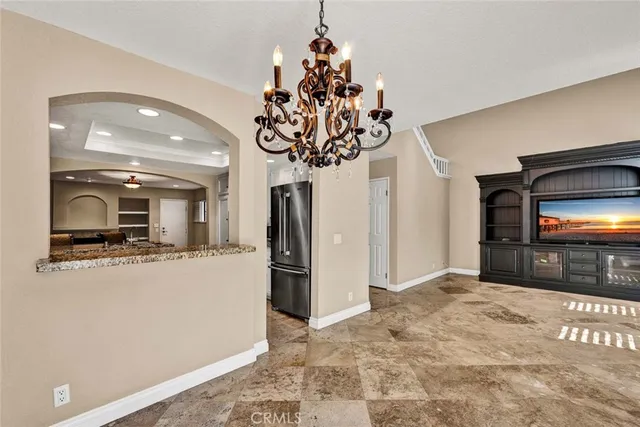 a large kitchen with a refrigerator and a counter top space