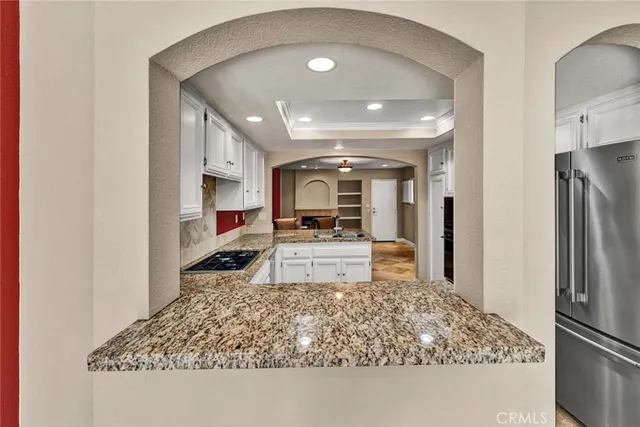 large kitchen with stainless steel appliances granite countertop a stove a sink and a refrigerator