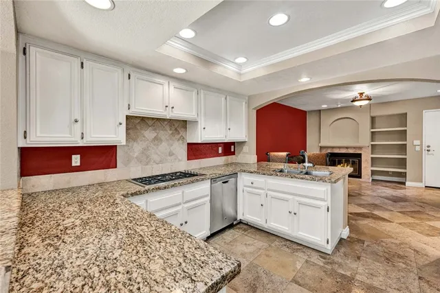 a kitchen that has a sink and a stove in it