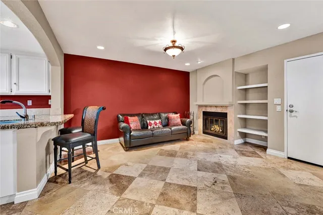 a living room with furniture a dining table and a fireplace
