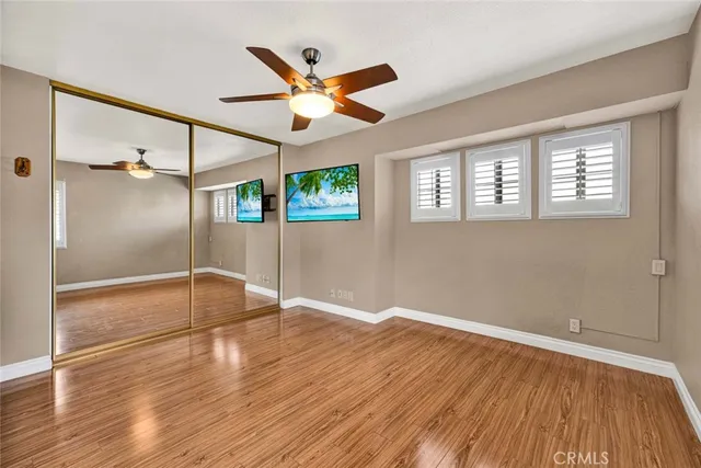 a bathroom with a granite countertop sink a toilet a mirror and shower