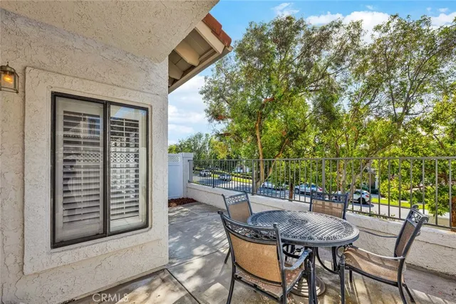 a balcony with table and chairs