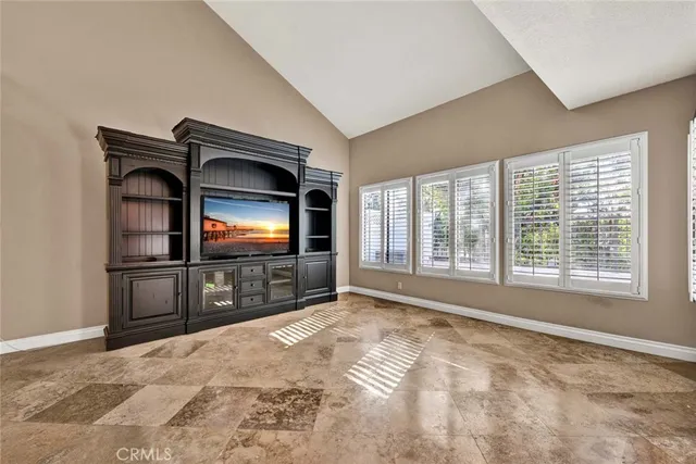 a view of empty room with a flat screen tv and a floor to ceiling window