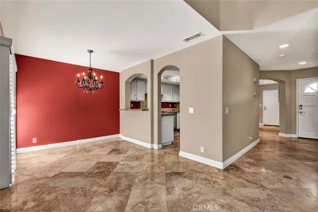 an empty room with closet and windows