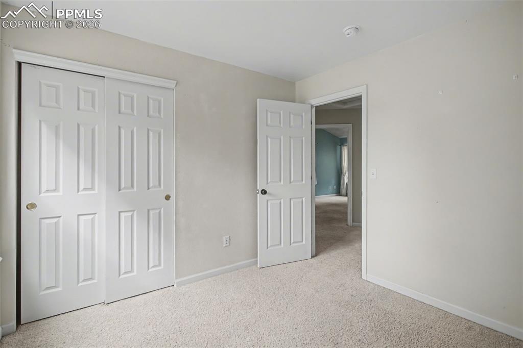 4944 Antelope Trail Elbert, CO 80106 - Photo 17 of 49 Unfurnished bedroom with light carpet and a closet