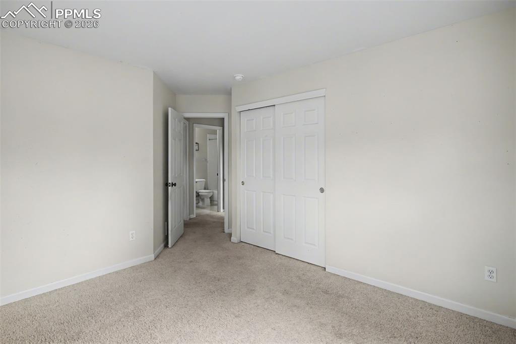 4944 Antelope Trail Elbert, CO 80106 - Photo 20 of 49 Unfurnished bedroom featuring light colored carpet and a closet