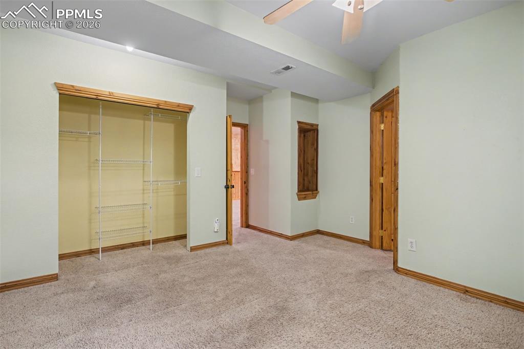 4944 Antelope Trail Elbert, CO 80106 - Photo 29 of 49 Unfurnished bedroom with a closet, light carpet, and ceiling fan