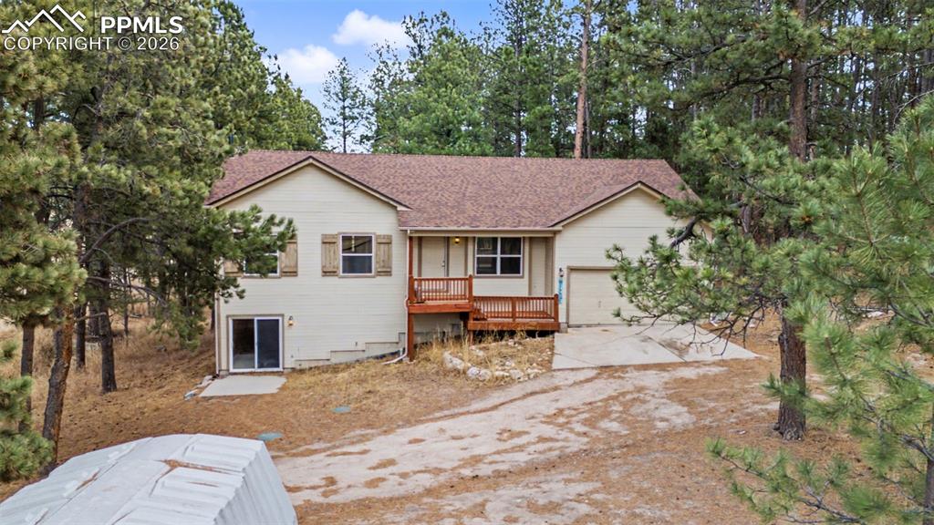 4944 Antelope Trail Elbert, CO 80106 - Photo 32 of 49 Ranch-style home with concrete driveway, an attached garage, and a shingled roof