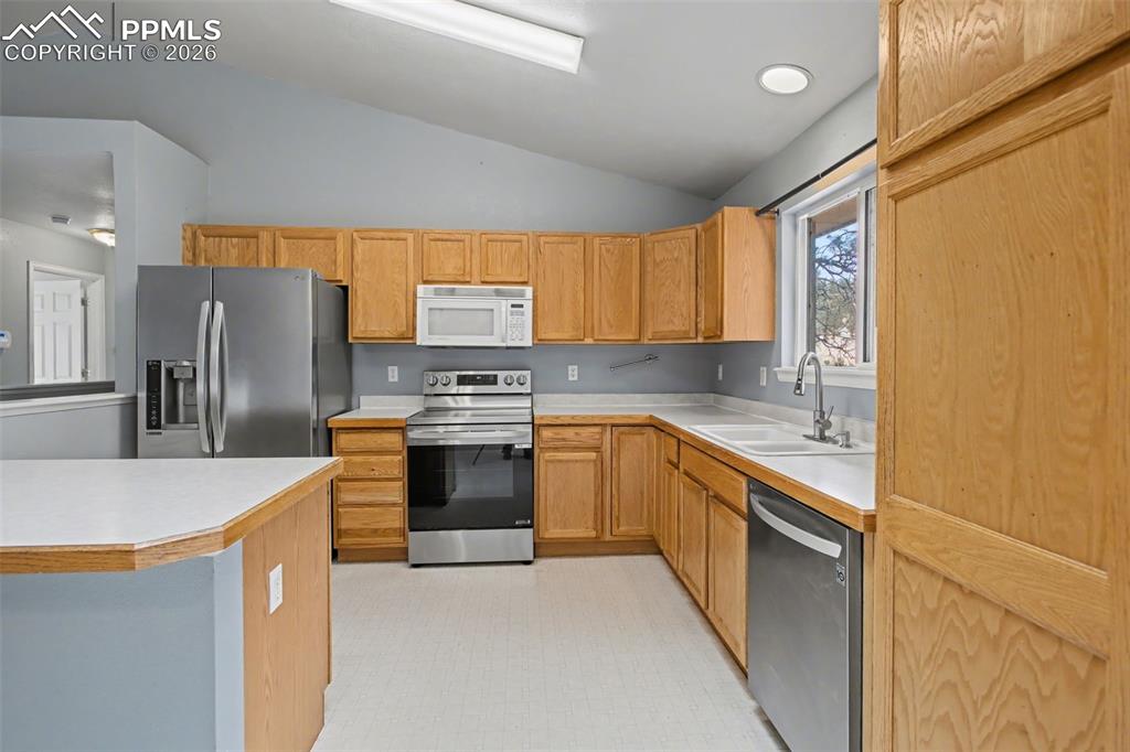 4944 Antelope Trail Elbert, CO 80106 - Photo 10 of 49 Kitchen featuring light countertops, stainless steel appliances, lofted ceiling, and light floors
