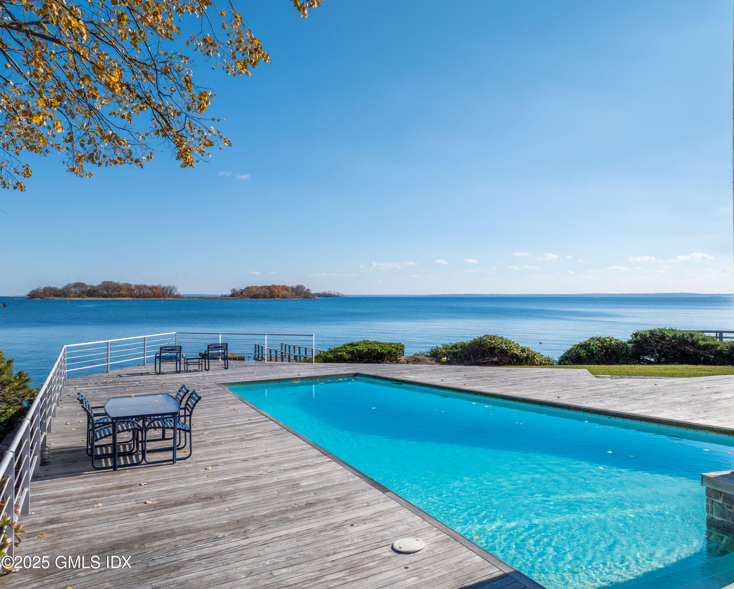 111 Byram Shore Road Greenwich, CT 06830 - Photo 4 of 23 a view of a swimming pool and an ocean