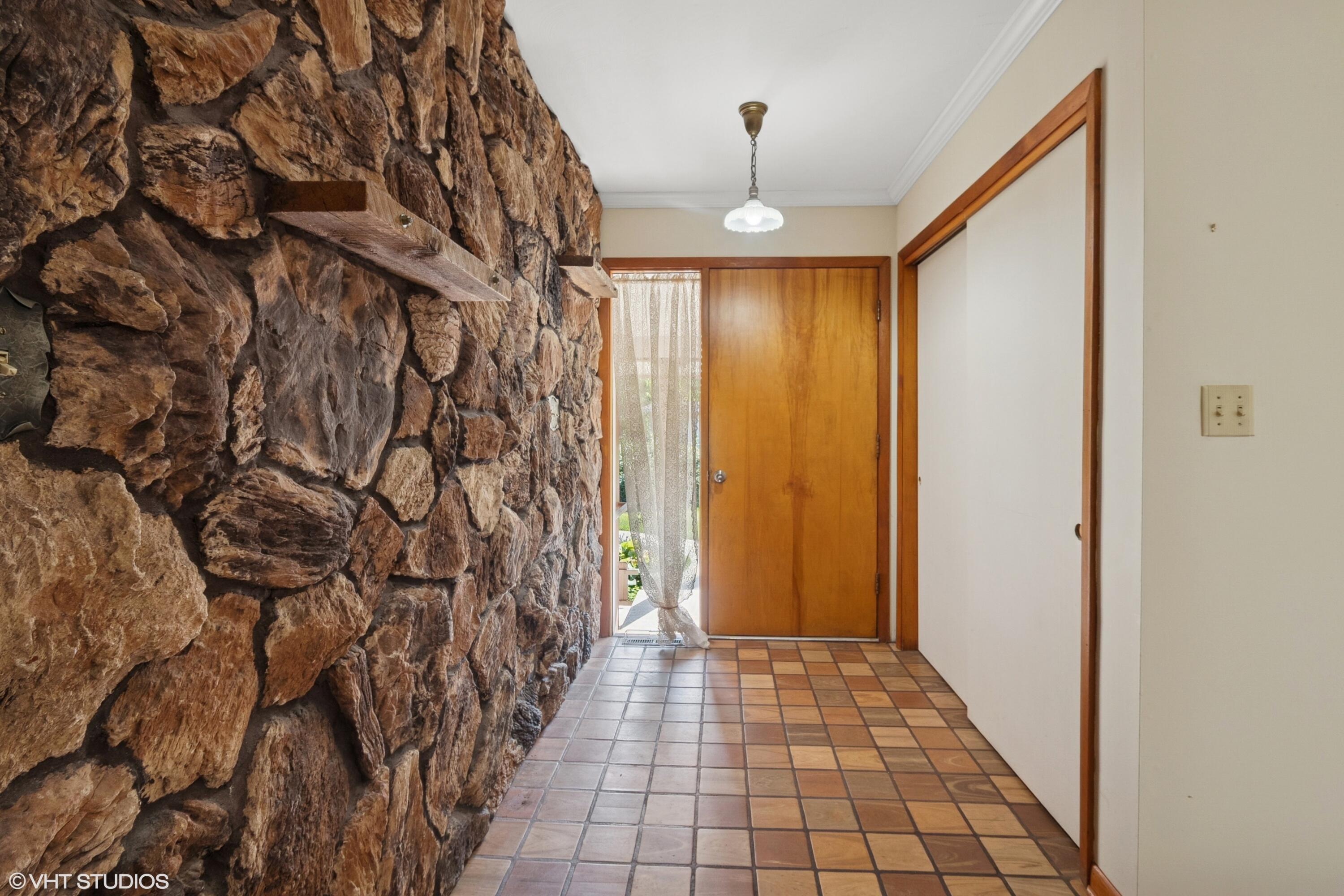 606 South 18th Street Chesterton, IN 46304 - Photo 2 of 24 a view of a hallway with wooden floor and a chandelier