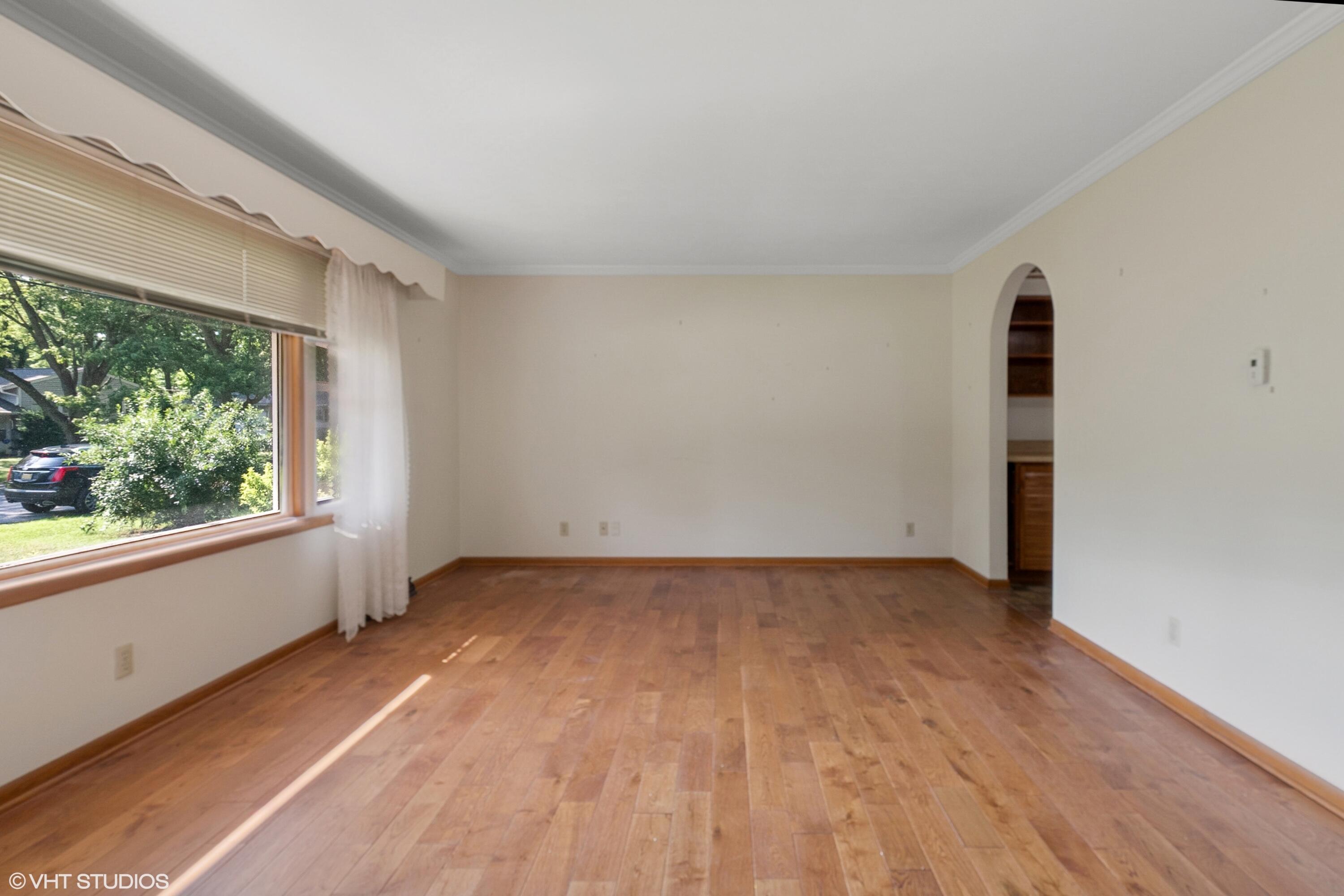 606 South 18th Street Chesterton, IN 46304 - Photo 4 of 24 an empty room with wooden floor and windows