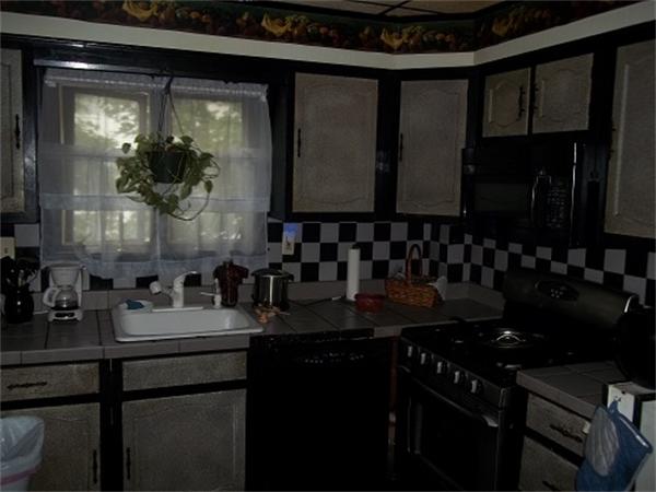 986 Middle Street Fall River, MA 02721 - Photo 5 of 11 a bathroom with a sink and a mirror