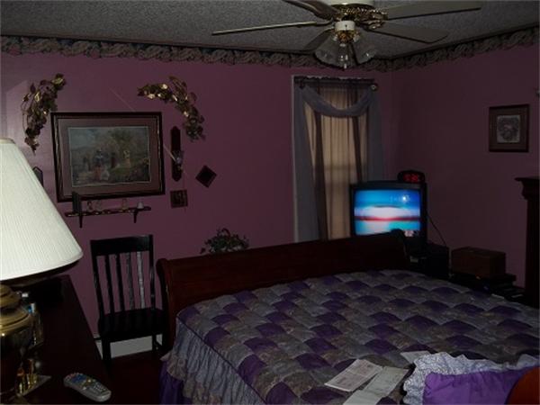 986 Middle Street Fall River, MA 02721 - Photo 10 of 11 a bedroom with a bed dresser and a flat screen tv