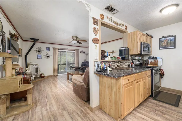 a kitchen with stainless steel appliances granite countertop a stove and a refrigerator