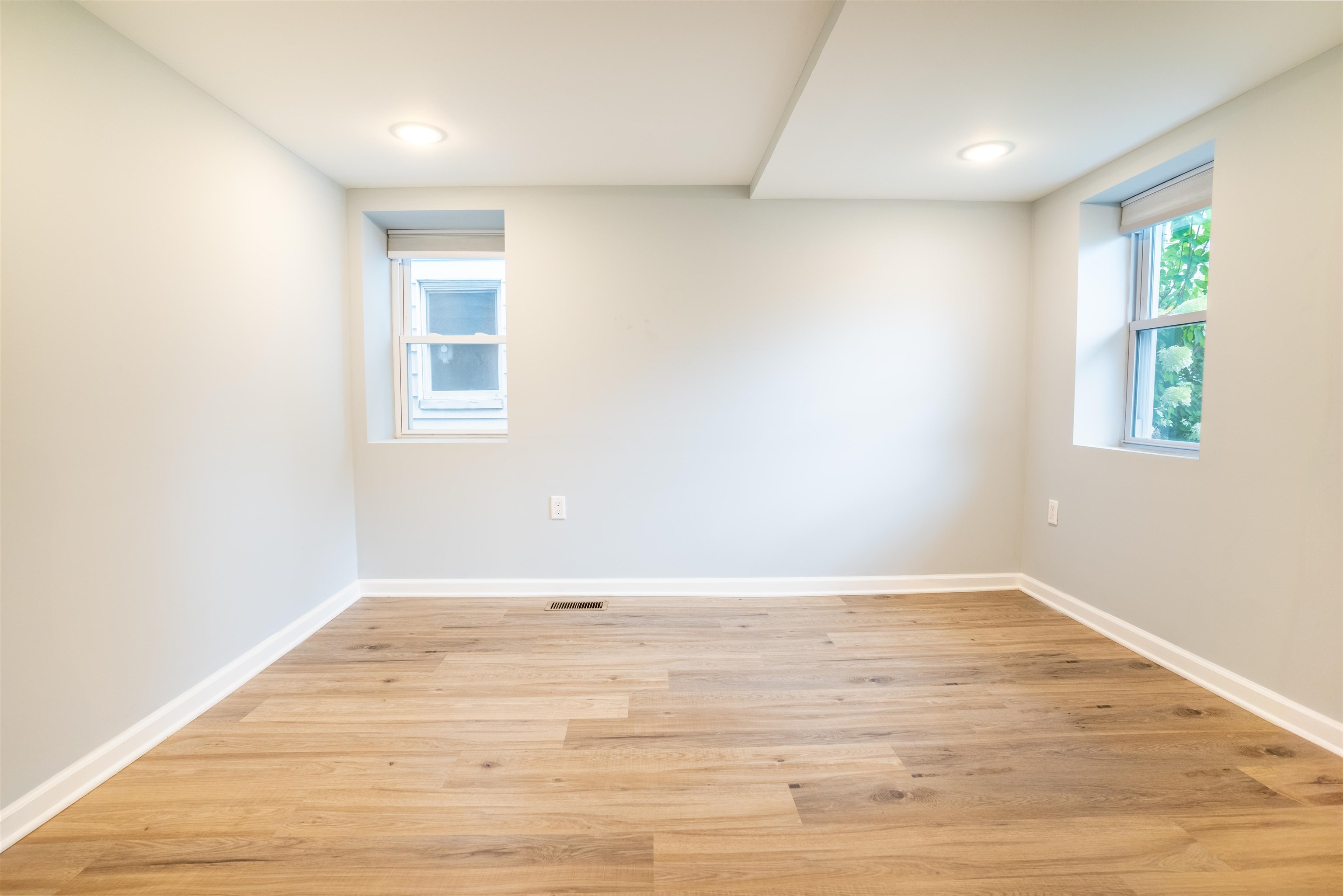 38 Mill Street, Unit 1 Bloomfield, NJ 07003 - Photo 13 of 20 an empty room with wooden floor and window