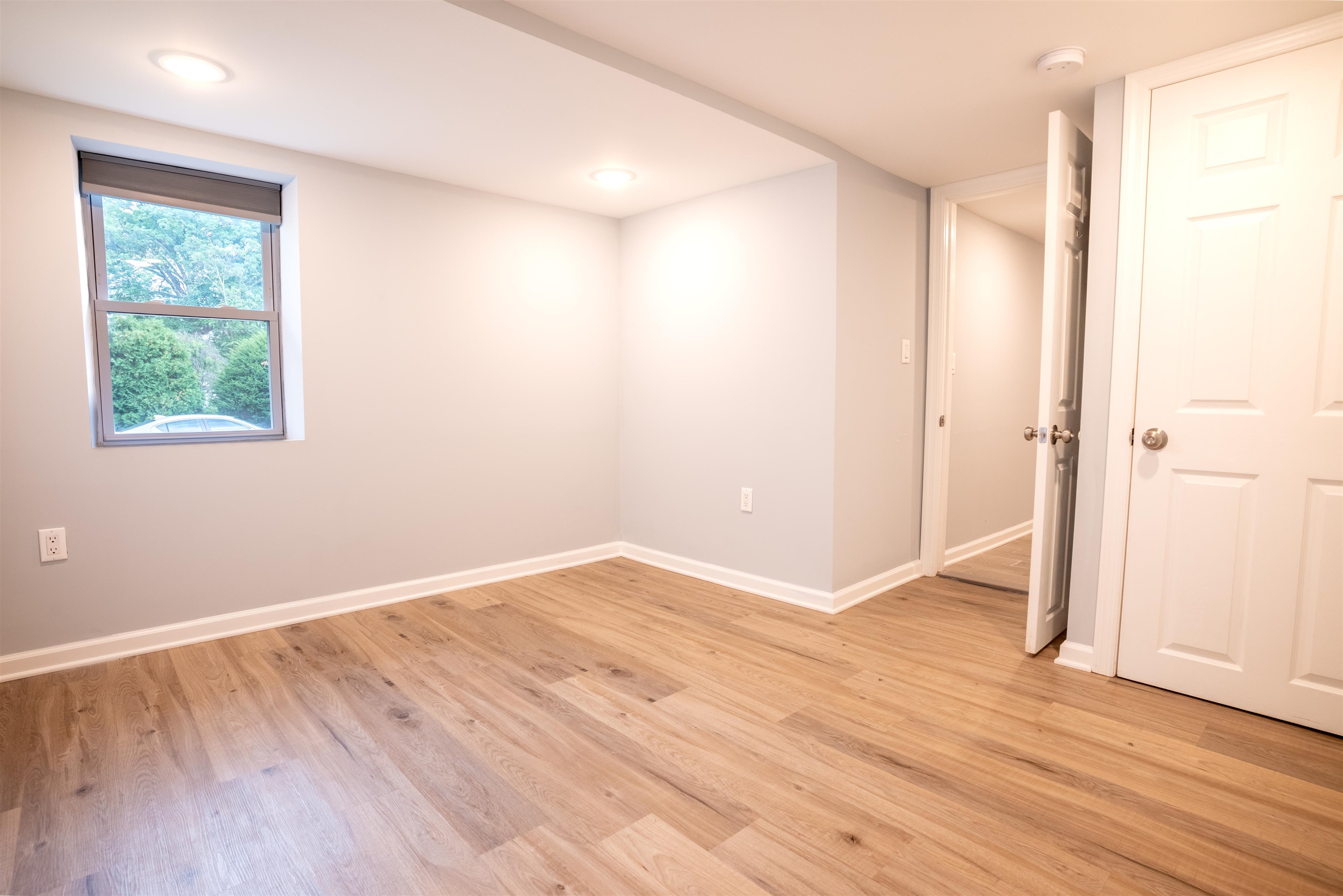 38 Mill Street, Unit 1 Bloomfield, NJ 07003 - Photo 14 of 20 a view of an empty room with wooden floor and a window