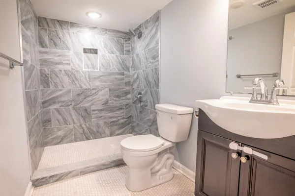 a bathroom with a sink toilet and shower