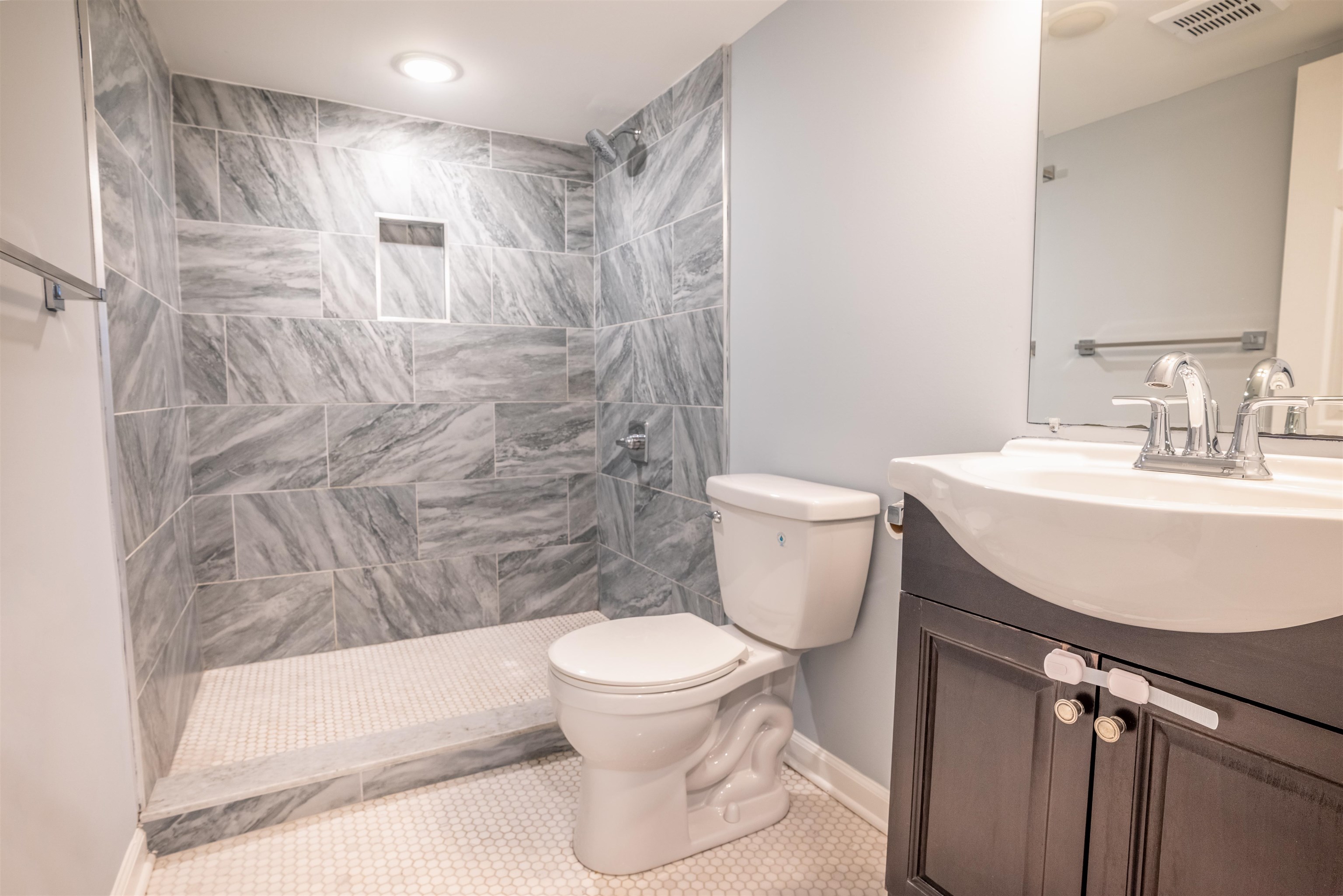 38 Mill Street, Unit 1 Bloomfield, NJ 07003 - Photo 16 of 20 a bathroom with a sink toilet and shower