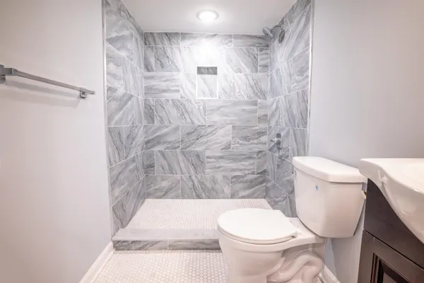 a white toilet sitting next to a shower curtain