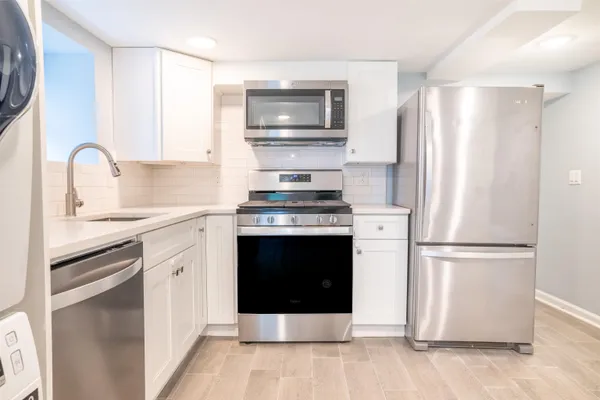 a kitchen with stainless steel appliances a refrigerator stove and sink